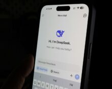 A person holding a cell phone in their hand