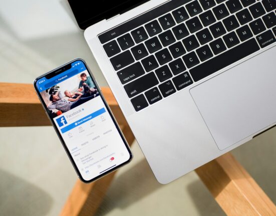 iPhone X beside MacBook